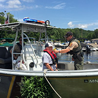 Checking boater with breathalizer - New DWI law now in effect
