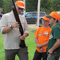 Instructor with kids - Register now for firearms safety classes