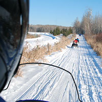 Snowmobilers riding on one of Minnesota's groomed trails.