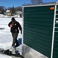 Officer checking that an ice house has identification