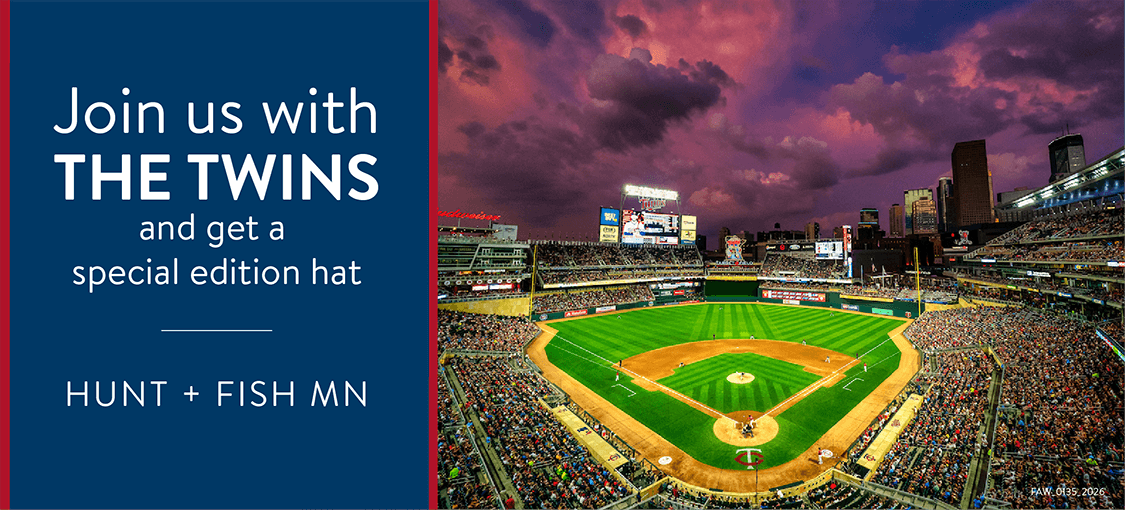 Join us with the Twins and get a special edition hat: Hunt + Fish MN A crowd has filled the bleachers of a baseball stadium at night to watch a Twins game.