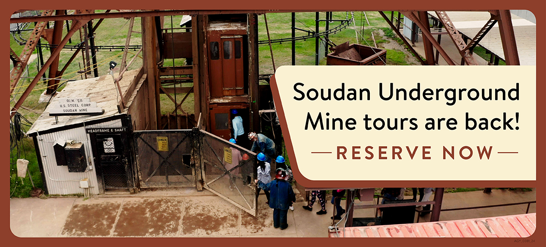A group of tourists (wearing protective hard hats) visit the OJ.M. Co. U.S. Steel Corp. Soudan Mine.